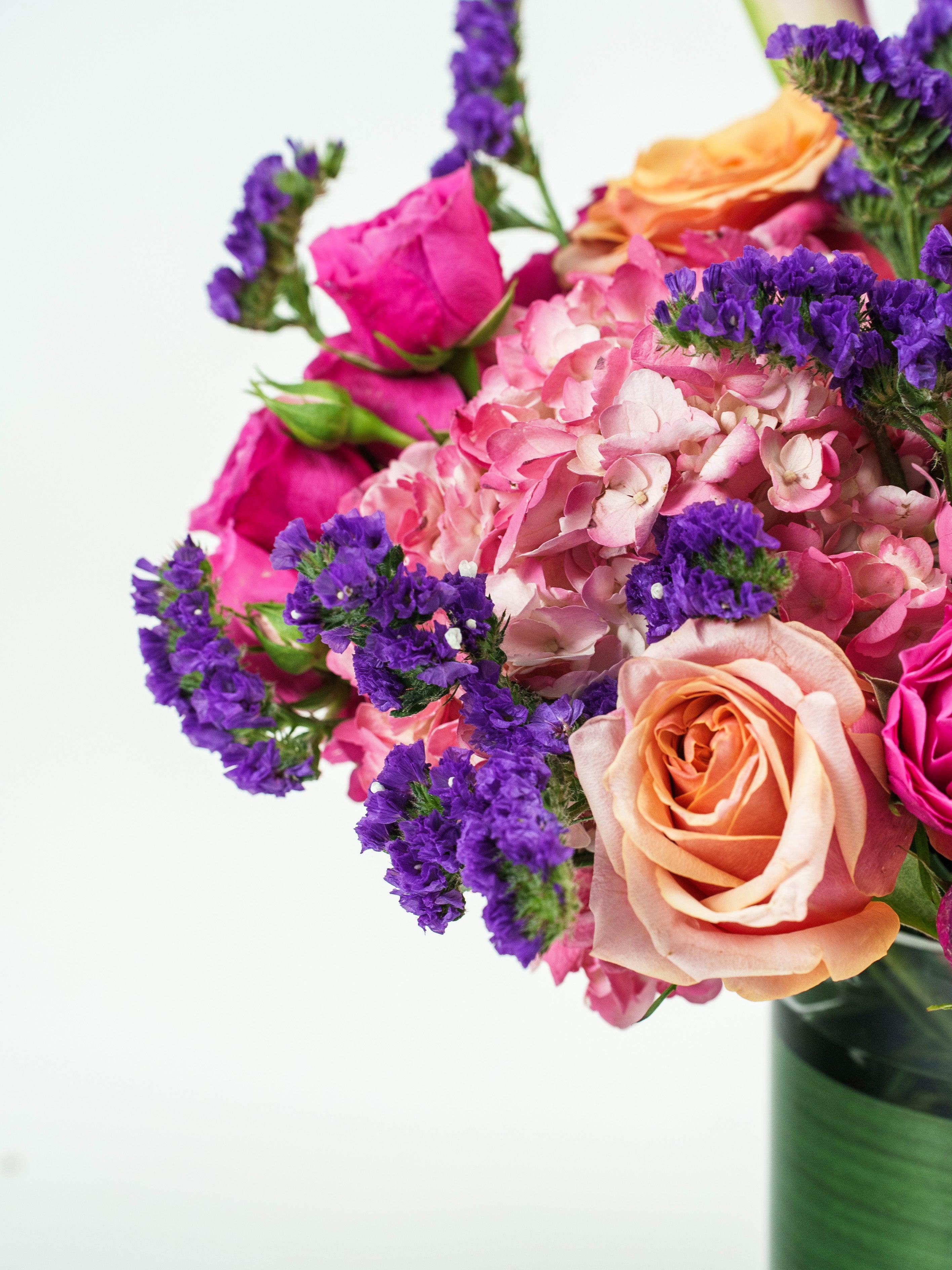 Whimsical Wonder bouquet with roses, lilies & calla lilies in a vase.